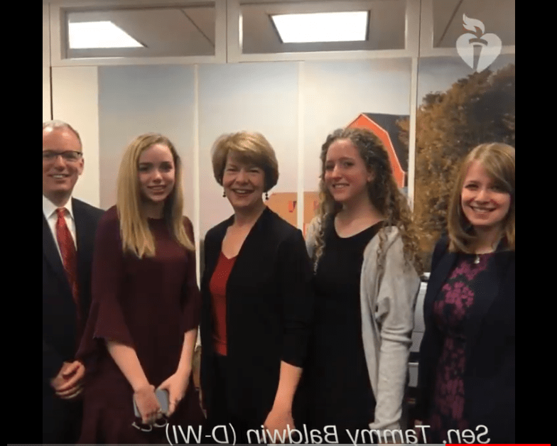 You're the Cure advocates take a photo with Senator Tammy Baldwin